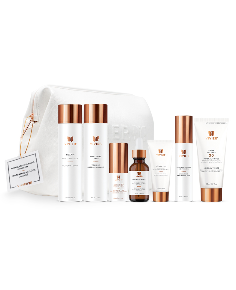 7 Vivier Skincare Programs That Target Dryness, Dark Spots, Aging & More A line of gold and white skincare products positioned in front of a white leather bag on a white backdrop.